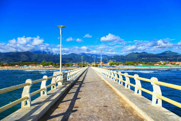 Pier footpath promenade, beach and Apuane mountains in Forte dei Marmi Versilia Tuscany Italy