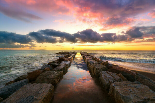 Pier in Maremma coast. Sunset time. Mediterranean sea Marina di Cecina, Tuscany, Italy Europe.